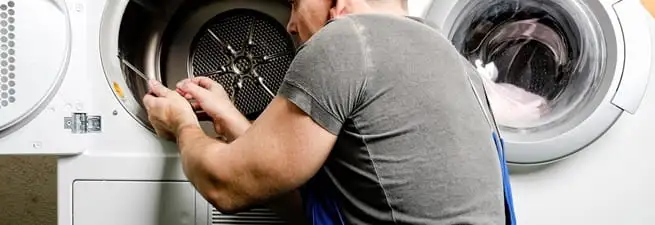 Dryer repair technician fixing a clothes dryer drum in Saint Petersburg, FL