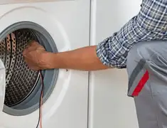 Dryer repair technician diagnosing and servicing a clothes dryer in Saint Petersburg, FL