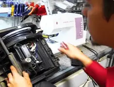 Vacuum repair technician servicing internal components on a workbench in Saint Petersburg, FL