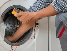 Washing machine repair technician testing a front-load washer with diagnostic tools in Saint Petersburg, FL
